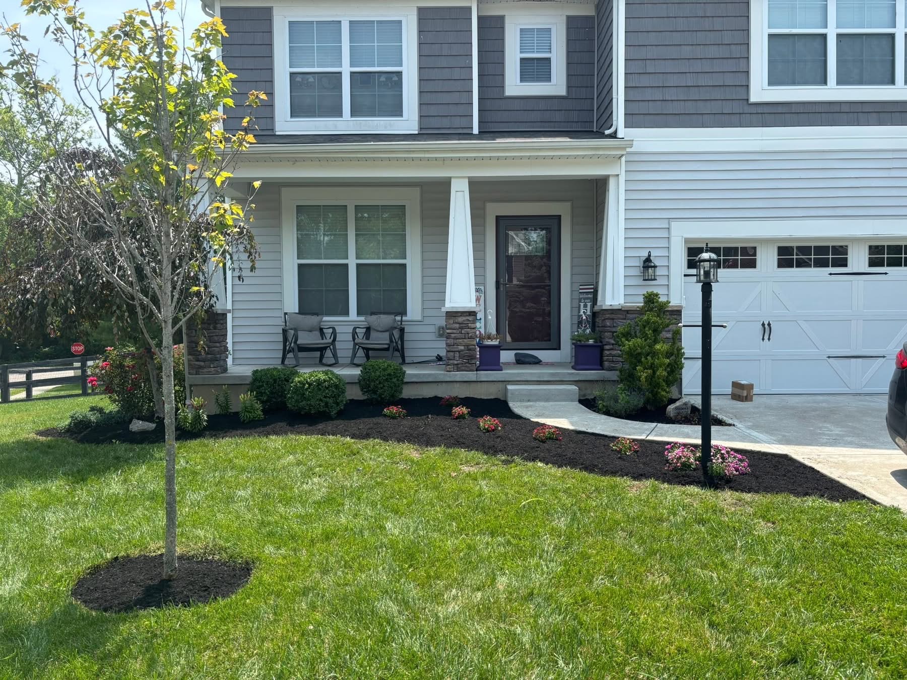Beautiful front yard landscape design with mulch beds and colorful plantings
