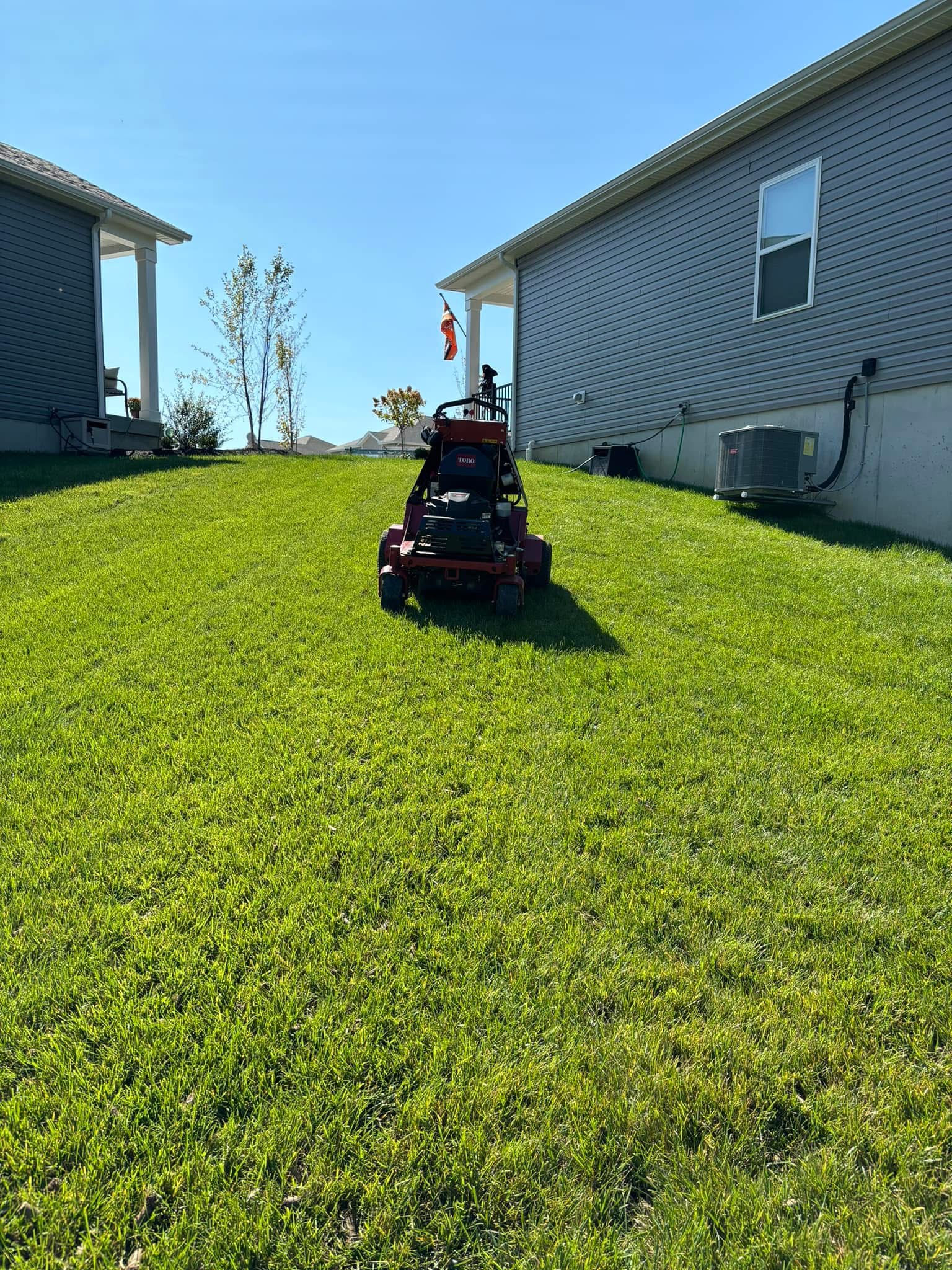 Lawn aerator on green residential grass — seasonal lawn care service